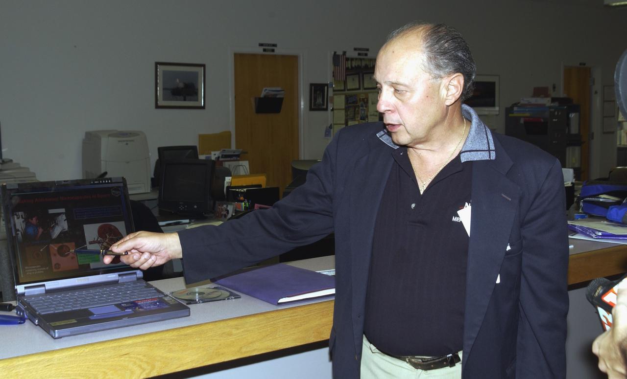 KENNEDY SPACE CENTER, FLA. - Dennis Morrison, senior biotech program scientist, talks to the media about an experiment recovered during the search for Columbia debris.  He is the principle investigator on microencapsulation and urokinase crystal growth included in the Commercial ITA Biomedical Experiments payload on mission STS-107.