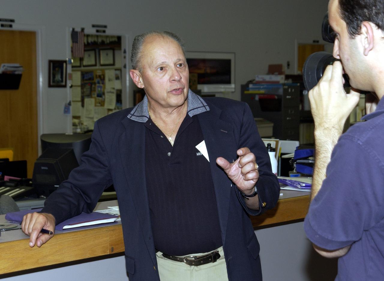 KENNEDY SPACE CENTER, FLA. - Dennis Morrison, senior biotech program scientist, talks to a reporter about an experiment recovered during the search for Columbia debris.  He is the principle investigator on microencapsulation and urokinase crystal growth included in the Commercial ITA Biomedical Experiments payload on mission STS-107.