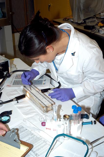 NASA image: KENNEDY SPACE CENTER, FLA. -  Valerie Cassanto, with Instrumentation Technology Associates, Inc., works on an experiment found during the search for Columbia debris.  Included in the Commercial ITA Biomedical Experiments payload on mission STS-107 are urokinase cancer research, microencapsulation of drugs, the Growth of Bacterial Biofilm on Surfaces during Spaceflight (GOBBSS), and tin crystal formation.