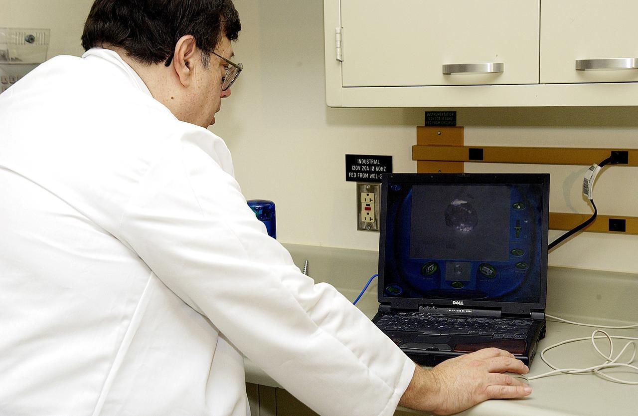 KENNEDY SPACE CENTER, FLA. -  Barry Perlman, Pembroke Pines Charter Middle School in Florida, prepares a computer to receive data from an experiment carried on mission STS-107. Several experiments were found during the search for Columbia debris. Included in the Commercial ITA Biomedical Experiments payload on mission STS-107 are urokinase cancer research, microencapsulation of drugs, the Growth of Bacterial Biofilm on Surfaces during Spaceflight (GOBBSS), and tin crystal formation. The latter was sponsored by the Pembroke Pines Charter Middle School.