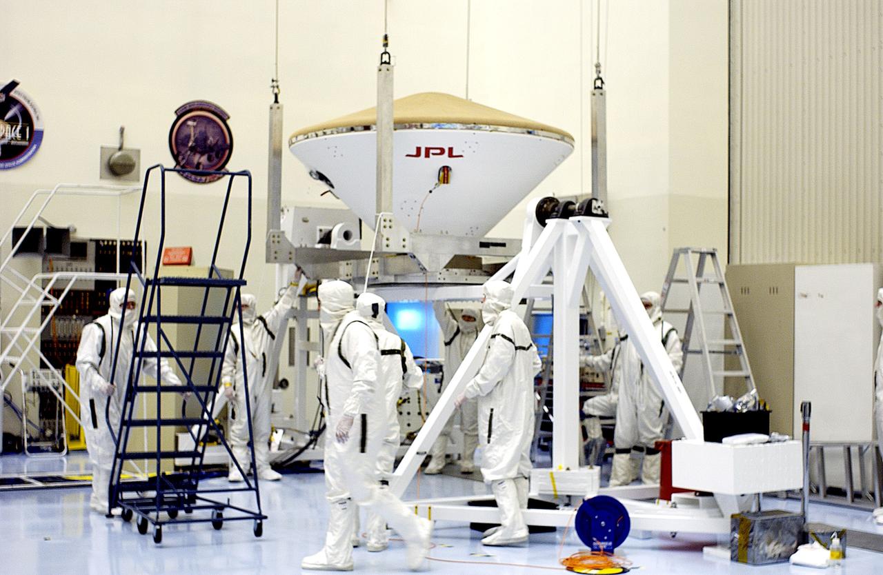 KENNEDY SPACE CENTER, FLA. -  An overhead crane is in place to lift the Mars Exploration Rover 2 (MER-2) entry vehicle to move it to a spin table for a dry-spin test.  The MER Mission consists of two identical rovers designed to cover roughly 110 yards each Martian day over various terrain. Each rover will carry five scientific instruments that will allow it to search for evidence of liquid water that may have been present in the planet's past.  Identical to each other, the rovers will land at different regions of Mars.  Launch for MER-2 (MER-A) is scheduled for June 5.
