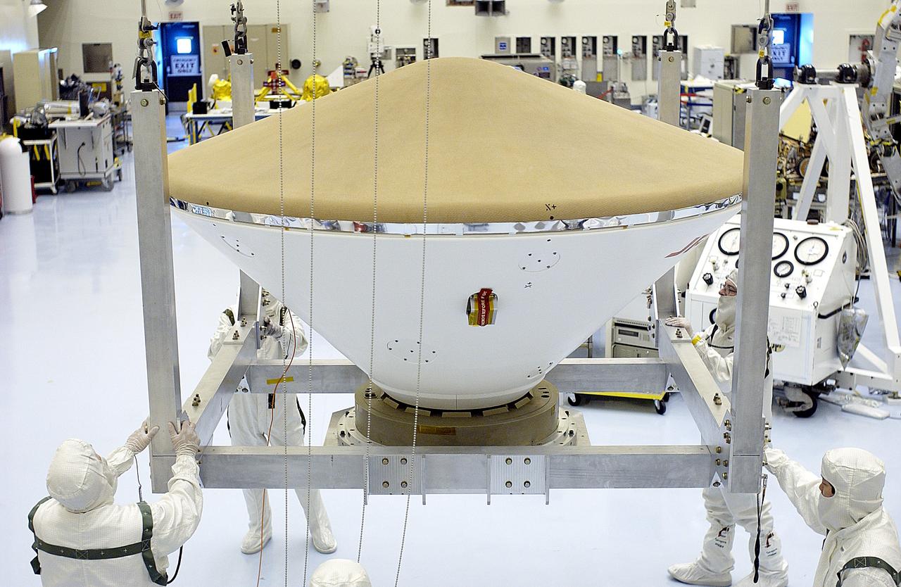 KENNEDY SPACE CENTER, FLA. - An overhead crane moves the Mars Exploration Rover 2 (MER-2) entry vehicle across the Payload Hazardous Servicing Facility toward a spin table for a dry-spin test.  The MER Mission consists of two identical rovers designed to cover roughly 110 yards each Martian day over various terrain. Each rover will carry five scientific instruments that will allow it to search for evidence of liquid water that may have been present in the planet's past.  Identical to each other, the rovers will land at different regions of Mars.  Launch for MER-2 (MER-A) is scheduled for June 5.