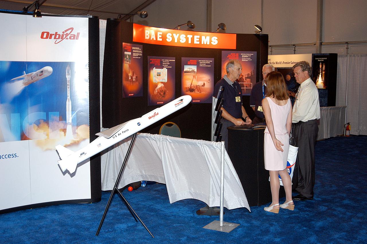 KENNEDY SPACE CENTER, FLA. -  Visitors stop at the Orbital Sciences booth during Space Congress Week, held April 29-May 2, 2003, in Cape Canaveral, Fla.  The Space Congress is an international conference that gathers attendees from the scientific community, the space industry workforce, educators and local supporting industries.  This year's event commemorated the 40th anniversary of the Kennedy Space Center and the Centennial of Flight.  The theme for the Space Congress was "Linking the Past to the Future: A Celebration of Space."