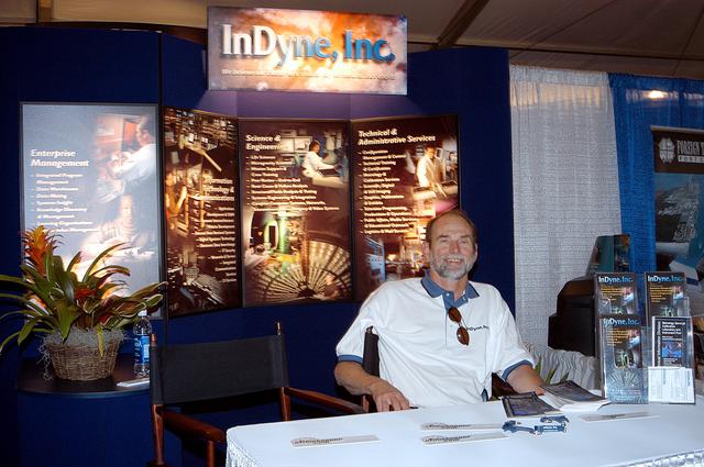 NASA image: KENNEDY SPACE CENTER, FLA. - At the InDyne Inc. booth during the 40th Space Congress, Frank Kiep is ready to meet visitors.  Held April 29-May 2, 2003, in Cape Canaveral, Fla., the Space Congress is an international conference that gathers attendees from the scientific community, the space industry workforce, educators and local supporting industries.  This year's event commemorated the 40th anniversary of the Kennedy Space Center and the Centennial of Flight.  The theme for the Space Congress was "Linking the Past to the Future: A Celebration of Space."