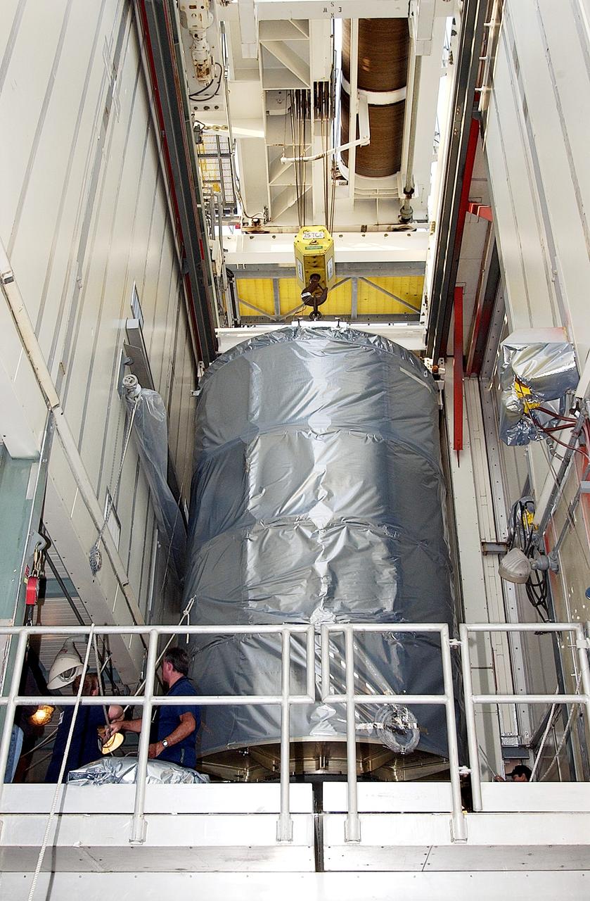 KENNEDY SPACE CENTER, FLA. - On Launch Complex 17-B, Cape Canaveral Air Force Station, the Space Infrared Telescope Facility (SIRTF) observatory is moved toward the outside of the launch tower.  It will be lowered and taken back to NASA Spacecraft Hangar AE. SIRTF will remain in the clean room at Hangar AE until it returns to the pad in early August.