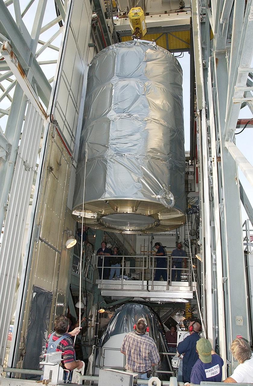 KENNEDY SPACE CENTER, FLA. - On Launch Complex 17-B, Cape Canaveral Air Force Station, the Space Infrared Telescope Facility (SIRTF) observatory is moved toward the outside of the launch tower.  It will be lowered and taken back to NASA Spacecraft Hangar AE. SIRTF will remain in the clean room at Hangar AE until it returns to the pad in early August.