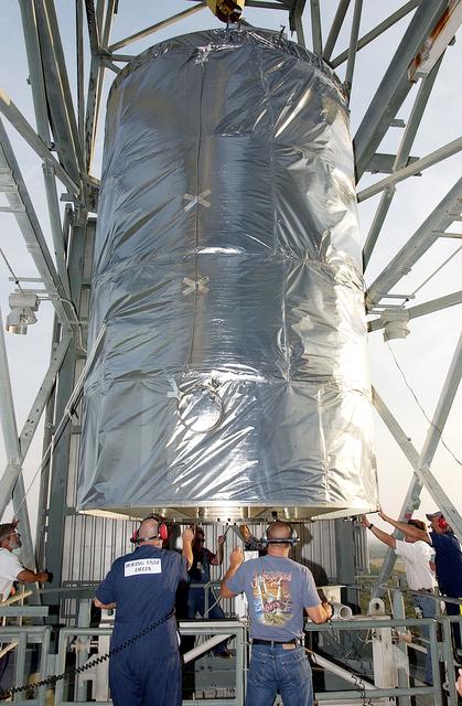 NASA image: KENNEDY SPACE CENTER, FLA. - On Launch Complex 17-B, Cape Canaveral Air Force Station, the Space Infrared Telescope Facility (SIRTF) observatory is ready to be lowered to the ground and taken back to NASA Spacecraft Hangar AE. SIRTF will remain in the clean room at Hangar AE until it returns to the pad in early August.