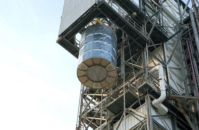 NASA image: KENNEDY SPACE CENTER, FLA. - On Launch Complex 17-B, Cape Canaveral Air Force Station, the Space Infrared Telescope Facility (SIRTF) observatory is lowered to the ground and taken back to NASA Spacecraft Hangar AE. SIRTF will remain in the clean room at Hangar AE until it returns to the pad in early August.
