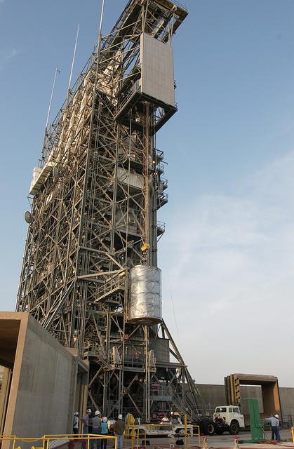 NASA image: KENNEDY SPACE CENTER, FLA. - On Launch Complex 17-B, Cape Canaveral Air Force Station, the Space Infrared Telescope Facility (SIRTF) observatory is lowered to the ground and taken back to NASA Spacecraft Hangar AE. SIRTF will remain in the clean room at Hangar AE until it returns to the pad in early August.