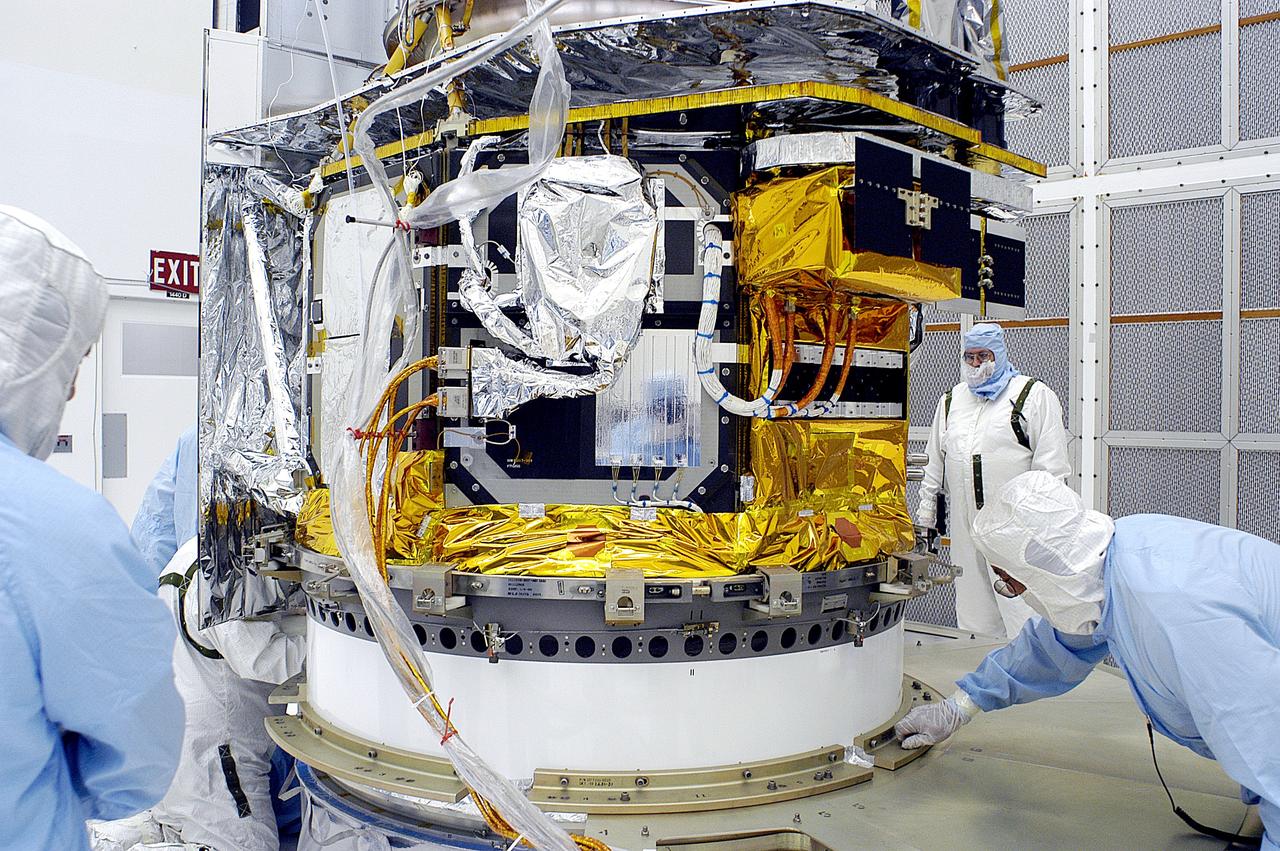 KENNEDY SPACE CENTER, FLA. -  In the NASA Spacecraft Hangar AE, the Space Infrared Telescope Facility (SIRTF), which has been returned to the hangar from the launch pad, is uncovered by workers following its arrival.   SIRTF will remain in the clean room until it returns to the pad in early August. One of NASA's largest infrared telescopes to be launched, SIRTF will obtain images and spectra by detecting the infrared energy, or heat, radiated by objects in space.