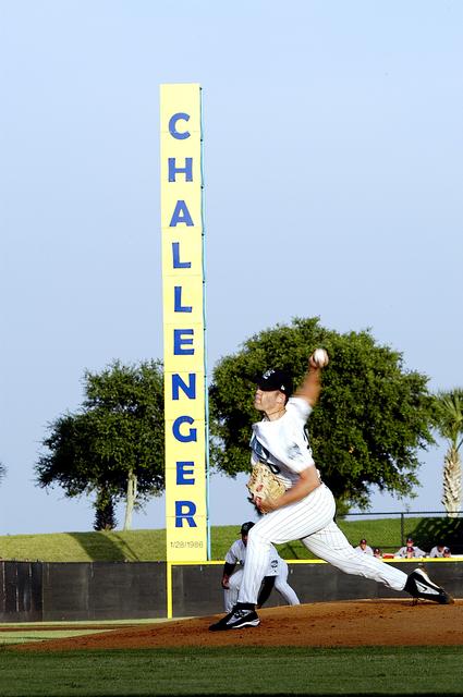 NASA image: KENNEDY SPACE CENTER, FLA. - The pitcher with the Brevard Manatees, a minor league baseball team in Central Florida, starts the game on a night that hosted KSC employees.  Before the game, attendees offered a moment of silence to honor the STS-107 crew and two recovery workers who died in a helicopter crash.