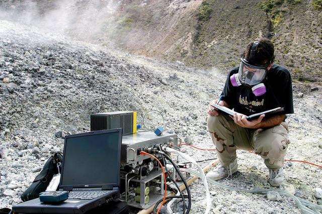 NASA image: KENNEDY SPACE CENTER, FLA. - Dr. Richard Arkin records data as the hazardous gas detection system AVEMS is used to analyze the toxic gases produced by active vents, called fumaroles, in the Turrialba volcano in Costa Rica.  He is using the Aircraft-based Volcanic Emission Mass Spectrometer (AVEMS) that determines the presence and concentration of various chemicals.  The AVEMS system has been developed for use in the Space Shuttle program, to detect toxic gas leaks and emissions in the Shuttle’s aft compartment and the crew compartment.
