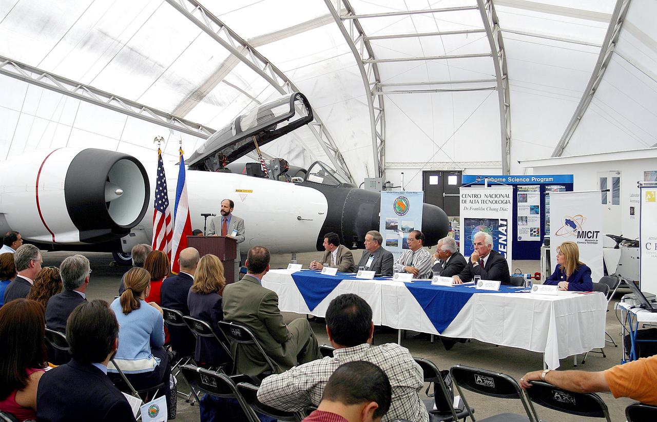 KENNEDY SPACE CENTER, FLA. -  At the airport in San Jose, Costa Rica, the NASA hangar is dedicated. The speaker is Hermann Faith, executive director, Costa Rica-USA (CRUSA) Foundation. At the table are (from left) Dr. Jorge Andres Diaz, head scientiest CARTA mission; Gary Shelton, NASA deployment manager; Dr. Pedro Leon, general director, National Center for Advanced Technology (CENAT); Dr. Rogelio Pardo, minister of science and tchnology; John Danilovioch, U.S. ambassador to Costa Rica; and Lic. Vilma Lopez, subdirector, Civil Aviation (DGAC).  NASA KSC has been testing its Aircraft-based Volcanic Emission Mass Spectrometer (AVEMS) in flights over the Turrialba volcano and in the crater, sampling and analyzing fresh volcanic gases in their natural chemical state.  The AVEMS system has been developed for use in the Space Shuttle program, to detect toxic gas leaks and emissions in the Shuttle’s aft compartment and the crew compartment.