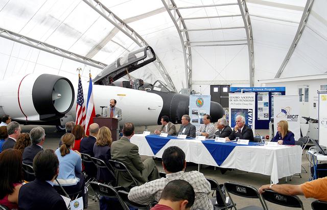 NASA image: KENNEDY SPACE CENTER, FLA. -  At the airport in San Jose, Costa Rica, the NASA hangar is dedicated. The speaker is Hermann Faith, executive director, Costa Rica-USA (CRUSA) Foundation. At the table are (from left) Dr. Jorge Andres Diaz, head scientiest CARTA mission; Gary Shelton, NASA deployment manager; Dr. Pedro Leon, general director, National Center for Advanced Technology (CENAT); Dr. Rogelio Pardo, minister of science and tchnology; John Danilovioch, U.S. ambassador to Costa Rica; and Lic. Vilma Lopez, subdirector, Civil Aviation (DGAC).  NASA KSC has been testing its Aircraft-based Volcanic Emission Mass Spectrometer (AVEMS) in flights over the Turrialba volcano and in the crater, sampling and analyzing fresh volcanic gases in their natural chemical state.  The AVEMS system has been developed for use in the Space Shuttle program, to detect toxic gas leaks and emissions in the Shuttle’s aft compartment and the crew compartment.