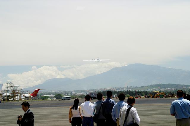 NASA image: KENNEDY SPACE CENTER, FLA. -  Reporters at the dedication ceremony of a NASA hangar at the San Jose, Costa Rica, airport observe the WB-57f takeoff for its sixth Costa Rican flight.  KSC and NASA researchers are testing the Aircraft-based Volcanic Emission Mass Spectrometer (AVEMS) that determines the presence and concentration of various chemicals.  It is being tested in flights over the Turrialba volcano in Costa Rica, and in the crater, sampling and analyzing fresh volcanic gases in their natural chemical state.  The AVEMS system has been developed for use in the Space Shuttle program, to detect toxic gas leaks and emissions in the Shuttle’s aft compartment and the crew compartment.