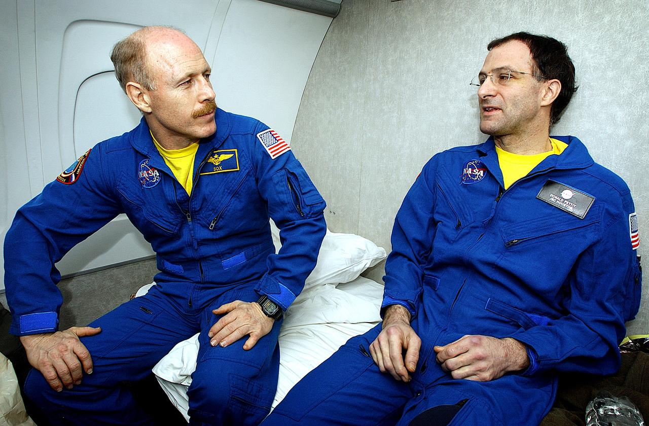 KAZAKHSTAN - Expedition Six Commander Ken Bowersox (left), and NASA ISS Science Officer Don Pettit (right) talk about their landing during the flight from Kazakhstan to Moscow. The Expedition Six crew spent 161 days in space, 159 manning the International Space Station. Photo Credit: NASA/Bill Ingalls