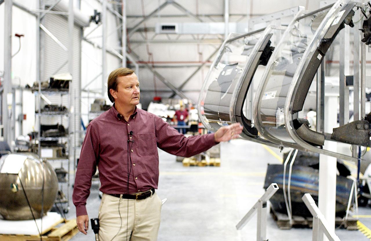KENNEDY SPACE CENTER, FLA. - While talking to the media in the RLV Hangar, Shuttle Launch Director Mike Leinbach points to the model of the leading edge of an orbiter’s left wing that is being used to reconstruct Columbia’s wing with the recovered debris.  The items shipped to KSC number more than 82,000 and weigh 84,800 pounds or 38 percent of the total dry weight of Columbia.  Of those items, 78,760 have been identified, with 753 placed on the left wing grid in the Hangar.
