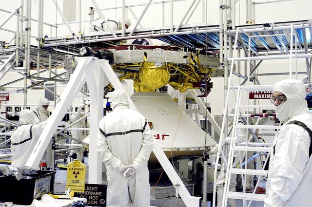 NASA image: KENNEDY SPACE CENTER, FLA. -  The Mars Exploration Rover 2 (MER-2) entry vehicle (below) is being mated to the cruise stage (above).   The cruise stage includes fuel tanks, thruster clusters and avionics for steering and propulsion.  NASA's twin Mars Exploration Rovers are designed to study the history of water on Mars. These robotic geologists are equipped with a robotic arm, a drilling tool, three spectrometers, and four pairs of cameras that allow them to have a human-like, 3D view of the terrain. Each rover could travel as far as 100 meters in one day to act as Mars scientists' eyes and hands, exploring an environment where humans can't yet go.  MER-2 is scheduled to launch June 5 as MER-A aboard a Delta rocket from Cape Canaveral Air Force Station.