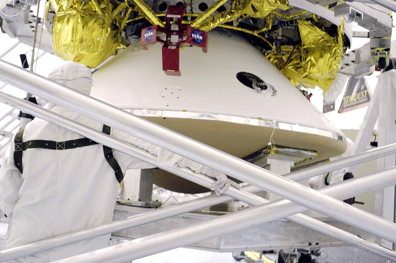 KENNEDY SPACE CENTER, FLA. - In the  Payload Hazardous Servicing Facility, the cruise stage is mated to the Mars Exploration Rover 2 (MER-2) entry vehicle.    The cruise stage includes fuel tanks, thruster clusters and avionics for steering and propulsion.  NASA's twin Mars Exploration Rovers are designed to study the history of water on Mars. These robotic geologists are equipped with a robotic arm, a drilling tool, three spectrometers, and four pairs of cameras that allow them to have a human-like, 3D view of the terrain. Each rover could travel as far as 100 meters in one day to act as Mars scientists' eyes and hands, exploring an environment where humans can't yet go.  MER-2 is scheduled to launch June 5 as MER-A aboard a Delta rocket from Cape Canaveral Air Force Station.