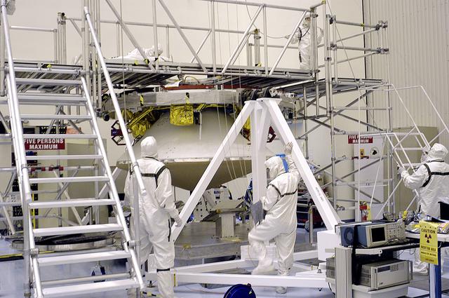 NASA image: KENNEDY SPACE CENTER, FLA. - In the  Payload Hazardous Servicing Facility, the cruise stage is mated to the Mars Exploration Rover 2 (MER-2) entry vehicle.    The cruise stage includes fuel tanks, thruster clusters and avionics for steering and propulsion.  NASA's twin Mars Exploration Rovers are designed to study the history of water on Mars. These robotic geologists are equipped with a robotic arm, a drilling tool, three spectrometers, and four pairs of cameras that allow them to have a human-like, 3D view of the terrain. Each rover could travel as far as 100 meters in one day to act as Mars scientists' eyes and hands, exploring an environment where humans can't yet go.  MER-2 is scheduled to launch June 5 as MER-A aboard a Delta rocket from Cape Canaveral Air Force Station.