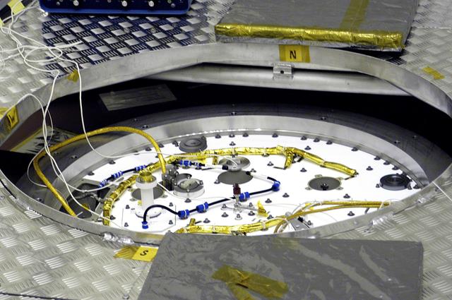 NASA image: KENNEDY SPACE CENTER, FLA. - A closeup of the cruise stage to be mated to the Mars Exploration Rover 2 (MER-2) entry vehicle.    The cruise stage includes fuel tanks, thruster clusters and avionics for steering and propulsion.  NASA's twin Mars Exploration Rovers are designed to study the history of water on Mars. These robotic geologists are equipped with a robotic arm, a drilling tool, three spectrometers, and four pairs of cameras that allow them to have a human-like, 3D view of the terrain. Each rover could travel as far as 100 meters in one day to act as Mars scientists' eyes and hands, exploring an environment where humans can't yet go.  MER-2 is scheduled to launch June 5 as MER-A aboard a Delta rocket from Cape Canaveral Air Force Station.