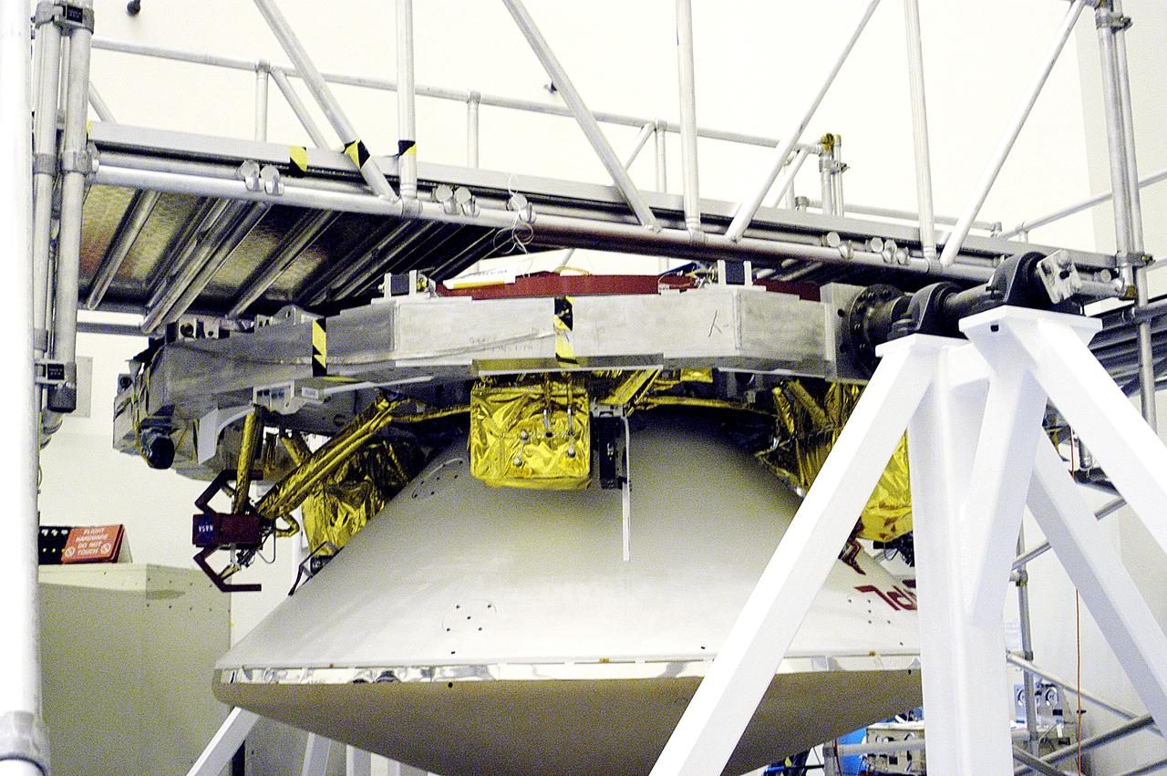 KENNEDY SPACE CENTER, FLA. - In the  Payload Hazardous Servicing Facility, the cruise stage is mated to the Mars Exploration Rover 2 (MER-2) entry vehicle.    The cruise stage includes fuel tanks, thruster clusters and avionics for steering and propulsion.  NASA's twin Mars Exploration Rovers are designed to study the history of water on Mars. These robotic geologists are equipped with a robotic arm, a drilling tool, three spectrometers, and four pairs of cameras that allow them to have a human-like, 3D view of the terrain. Each rover could travel as far as 100 meters in one day to act as Mars scientists' eyes and hands, exploring an environment where humans can't yet go.  MER-2 is scheduled to launch June 5 as MER-A aboard a Delta rocket from Cape Canaveral Air Force Station.