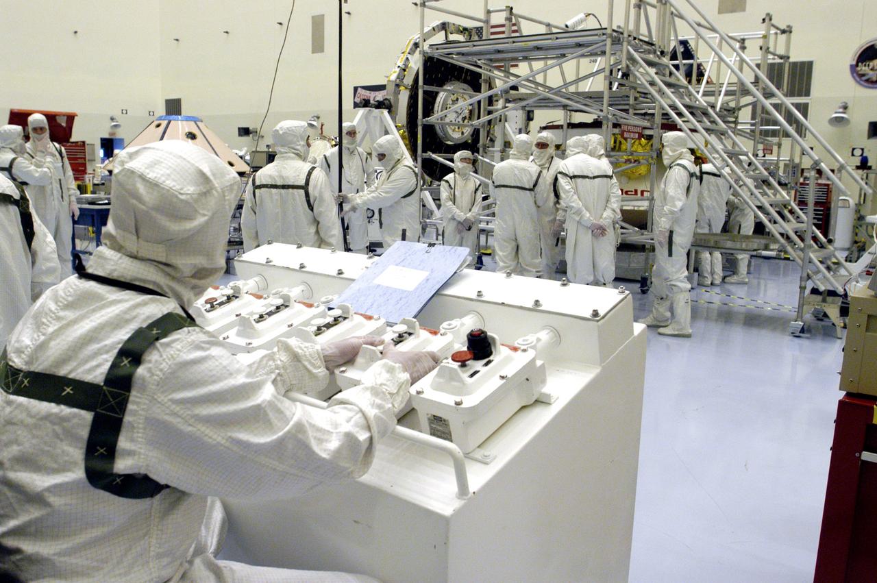 KENNEDY SPACE CENTER, FLA. - Workers in the Payload Hazardous Servicing Facility are preparing to determine weight and center of gravity for the Mars Exploration Rover 2 (MER-2).  NASA's twin Mars Exploration Rovers are designed to study the history of water on Mars. These robotic geologists are equipped with a robotic arm, a drilling tool, three spectrometers, and four pairs of cameras that allow them to have a human-like, 3D view of the terrain. Each rover could travel as far as 100 meters in one day to act as Mars scientists' eyes and hands, exploring an environment where humans can't yet go.  Launch of MER-2 is scheduled for June 5 from Cape Canaveral Air Force Station.