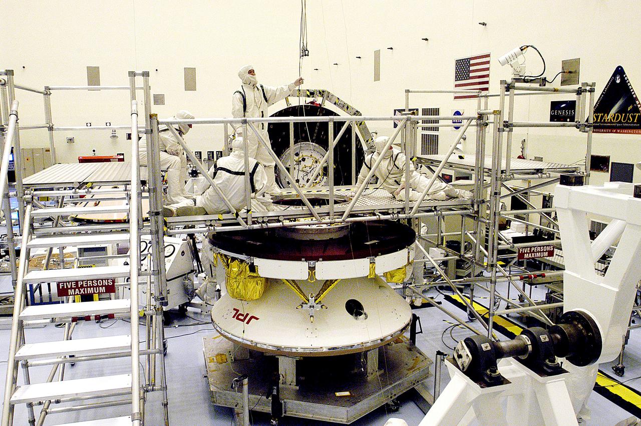 KENNEDY SPACE CENTER, FLA. - Workers in the Payload Hazardous Servicing Facility prepare the Mars Exploration Rover 2 (MER-2) for a weight and center of gravity determination.  NASA's twin Mars Exploration Rovers are designed to study the history of water on Mars. These robotic geologists are equipped with a robotic arm, a drilling tool, three spectrometers, and four pairs of cameras that allow them to have a human-like, 3D view of the terrain. Each rover could travel as far as 100 meters in one day to act as Mars scientists' eyes and hands, exploring an environment where humans can't yet go.  Launch of MER-2 is scheduled for June 5 from Cape Canaveral Air Force Station.