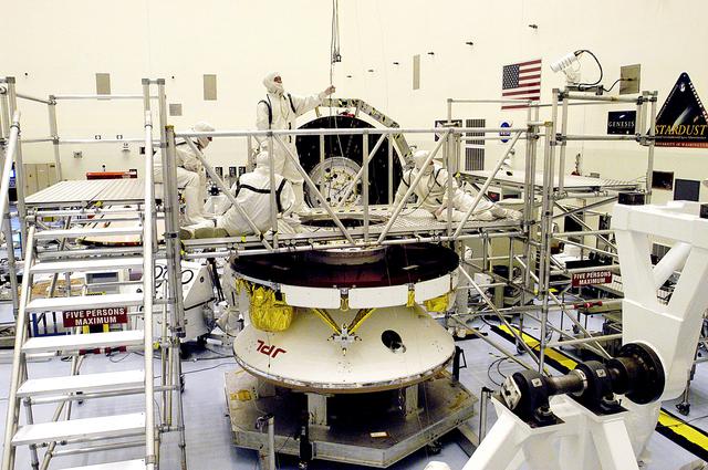 NASA image: KENNEDY SPACE CENTER, FLA. - Workers in the Payload Hazardous Servicing Facility prepare the Mars Exploration Rover 2 (MER-2) for a weight and center of gravity determination.  NASA's twin Mars Exploration Rovers are designed to study the history of water on Mars. These robotic geologists are equipped with a robotic arm, a drilling tool, three spectrometers, and four pairs of cameras that allow them to have a human-like, 3D view of the terrain. Each rover could travel as far as 100 meters in one day to act as Mars scientists' eyes and hands, exploring an environment where humans can't yet go.  Launch of MER-2 is scheduled for June 5 from Cape Canaveral Air Force Station.