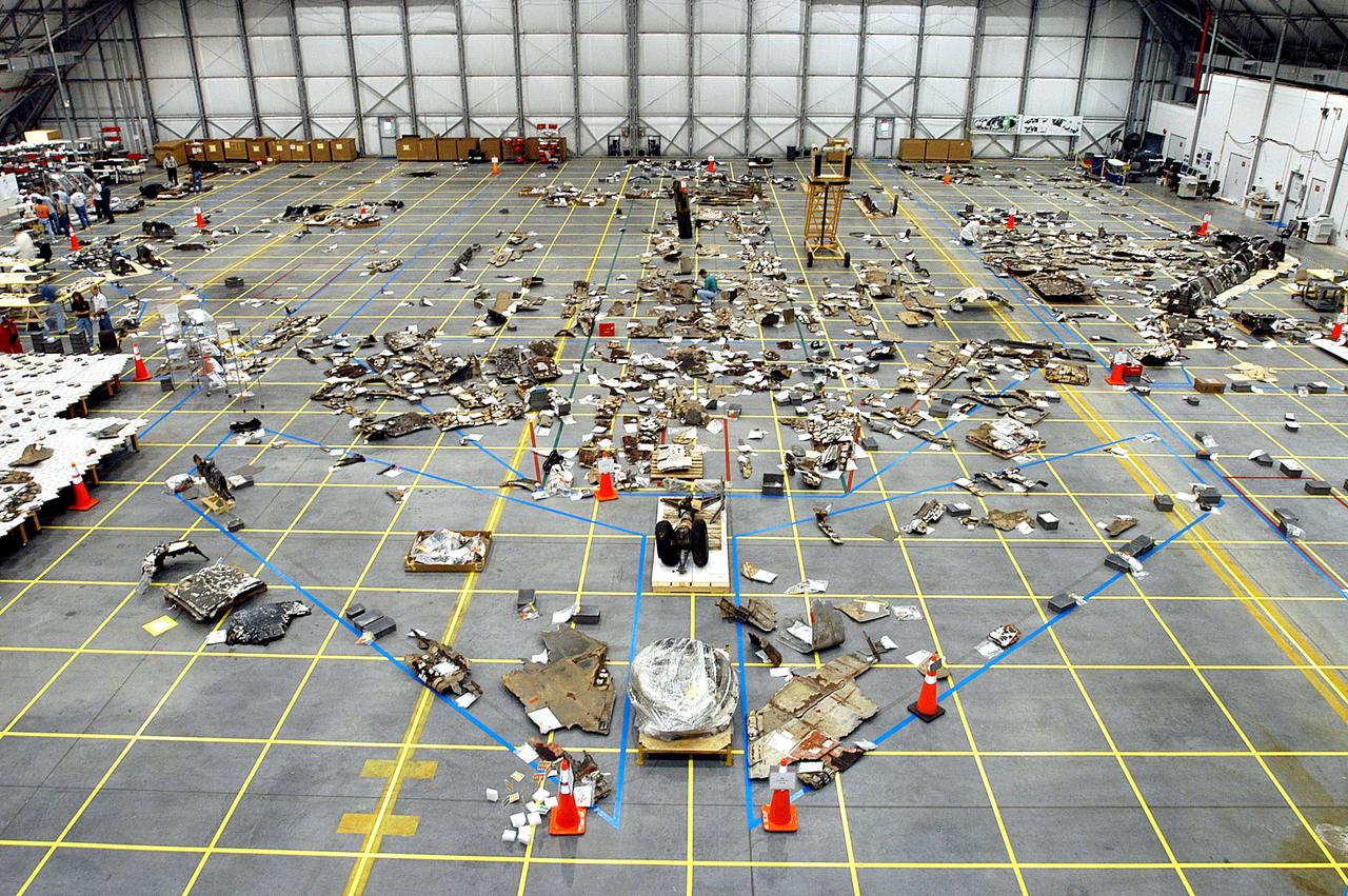 KENNEDY SPACE CENTER, FLA. -  The floor of the RLV Hangar is full of pieces of Columbia debris delivered from the search and recovery efforts in East Texas.  The items shipped to KSC number more than 82,000 and weigh 84,800 pounds or 38 percent of the total dry weight of Columbia. Of those items, 78,760 have been identified, with 753 placed on the left wing grid in the Hangar.