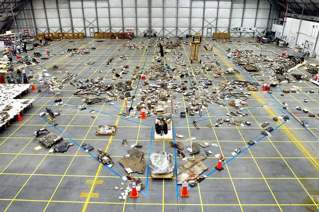 NASA image: KENNEDY SPACE CENTER, FLA. -  The floor of the RLV Hangar is full of pieces of Columbia debris delivered from the search and recovery efforts in East Texas.  The items shipped to KSC number more than 82,000 and weigh 84,800 pounds or 38 percent of the total dry weight of Columbia. Of those items, 78,760 have been identified, with 753 placed on the left wing grid in the Hangar.