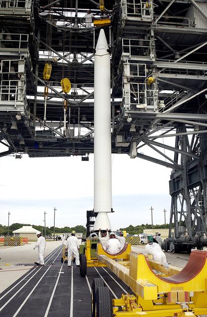 NASA image: KENNEDY SPACE CENTER, FLA. - On Launch Complex 17-A, Cape Canaveral Air Force Station, workers complete raising a solid rocket booster to a vertical position.  It will be lifted up the launch tower and mated to the Delta rocket to launch Mars Exploration Rover 2. NASA’s twin Mars Exploration Rovers are designed to study the history of water on Mars. These robotic geologists are equipped with a robotic arm, a drilling tool, three spectrometers, and four pairs of cameras that allow them to have a human-like, 3D view of the terrain. Each rover could travel as far as 100 meters in one day to act as Mars scientists' eyes and hands, exploring an environment where humans can’t yet go.  MER-2 is scheduled to launch June 5 as MER-A.  MER-1 (MER-B) will launch June 25.