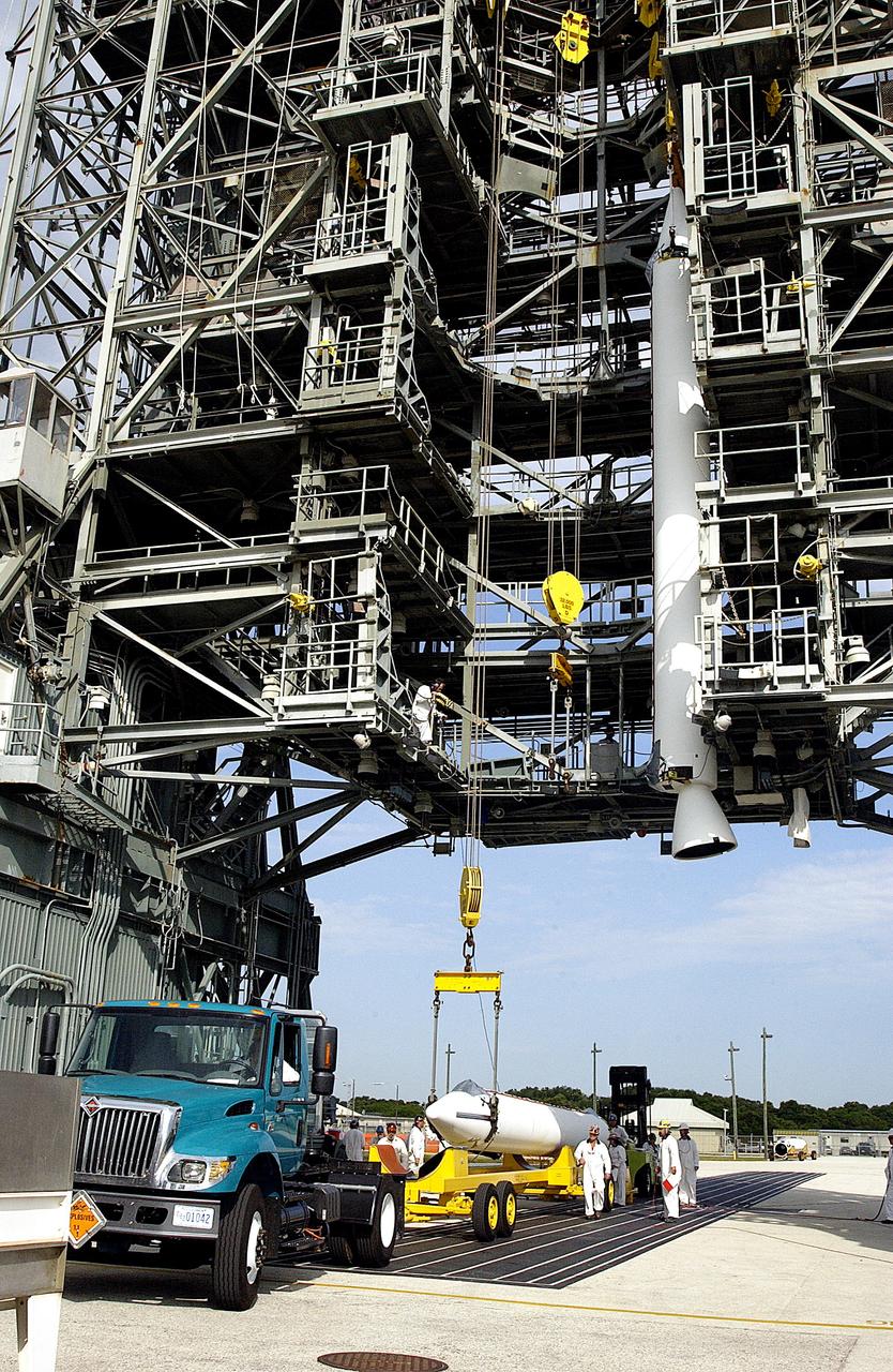 KENNEDY SPACE CENTER, FLA. -  While one solid rocket booster (SRB) is suspended in the launch tower on Launch Complex 17-A, Cape Canaveral Air Force Station, another is raised from its transporter for a similar lift.  They are two of nine SRBs that will be mated to the Delta rocket to launch Mars Exploration Rover 2. NASA’s twin Mars Exploration Rovers are designed to study the history of water on Mars. These robotic geologists are equipped with a robotic arm, a drilling tool, three spectrometers, and four pairs of cameras that allow them to have a human-like, 3D view of the terrain. Each rover could travel as far as 100 meters in one day to act as Mars scientists' eyes and hands, exploring an environment where humans can’t yet go.  MER-2 is scheduled to launch June 5 as MER-A.  MER-1 (MER-B) will launch June 25.