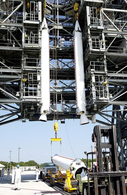 KENNEDY SPACE CENTER, FLA. - While two solid rocket boosters (SRBs) are suspended in the launch tower on Launch Complex 17-A, Cape Canaveral Air Force Station, another is being raised from its transporter for a similar lift.  They are three of nine SRBs that will be mated to the Delta rocket to launch Mars Exploration Rover 2. NASA’s twin Mars Exploration Rovers are designed to study the history of water on Mars. These robotic geologists are equipped with a robotic arm, a drilling tool, three spectrometers, and four pairs of cameras that allow them to have a human-like, 3D view of the terrain. Each rover could travel as far as 100 meters in one day to act as Mars scientists' eyes and hands, exploring an environment where humans can’t yet go.  MER-2 is scheduled to launch June 5 as MER-A.  MER-1 (MER-B) will launch June 25.