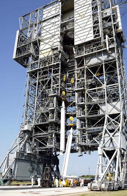 KENNEDY SPACE CENTER, FLA. - A third solid rocket booster (SRB) is lifted up the launch tower  on Launch Complex 17-A, Cape Canaveral Air Force Station.  They are three of nine SRBs that will be mated to the Delta rocket to launch Mars Exploration Rover 2. NASA’s twin Mars Exploration Rovers are designed to study the history of water on Mars. These robotic geologists are equipped with a robotic arm, a drilling tool, three spectrometers, and four pairs of cameras that allow them to have a human-like, 3D view of the terrain. Each rover could travel as far as 100 meters in one day to act as Mars scientists' eyes and hands, exploring an environment where humans can’t yet go.  MER-2 is scheduled to launch June 5 as MER-A.  MER-1 (MER-B) will launch June 25.