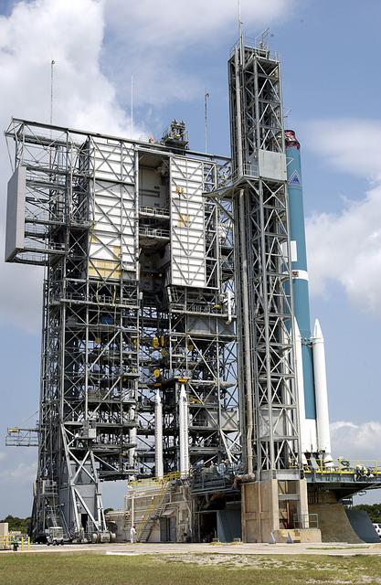 NASA image: KENNEDY SPACE CENTER, FLA. - At right is the Delta II rocket on Launch Complex 17-A, Cape Canaveral Air Force Station, that will launch Mars Exploration Rover 2 (MER-2) on June 5.  In the center are three more solid rocket boosters that will be added to the Delta, which will carry nine in all.  NASA’s twin Mars Exploration Rovers are designed to study the history of water on Mars. These robotic geologists are equipped with a robotic arm, a drilling tool, three spectrometers, and four pairs of cameras that allow them to have a human-like, 3D view of the terrain. Each rover could travel as far as 100 meters in one day to act as Mars scientists' eyes and hands, exploring an environment where humans can’t yet go.  MER-2 is scheduled to launch as MER-A.  MER-1 (MER-B) will launch June 25.
