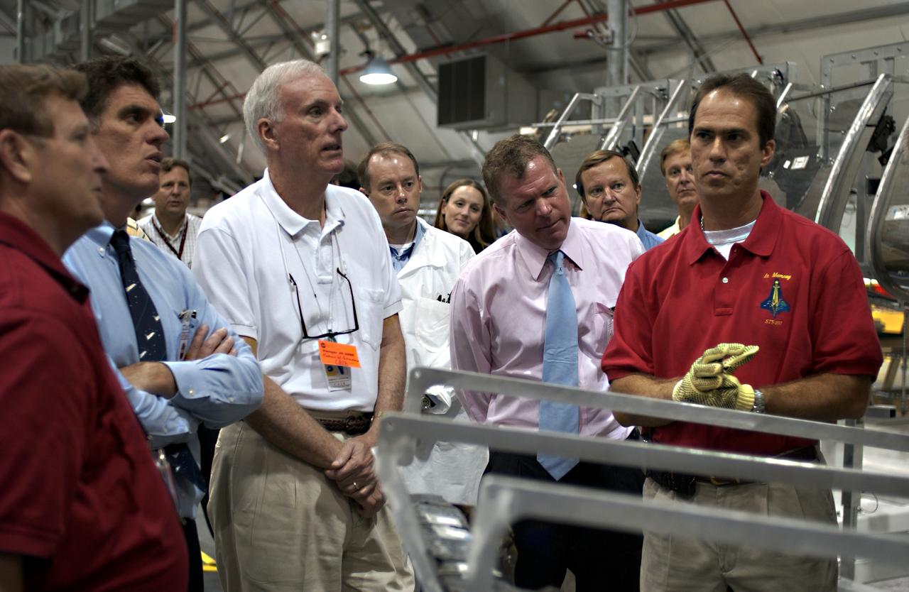 KENNEDY SPACE CENTER, FLA. - In the RLV Hangar, Adm. Harold Gehman (second from right) , chairman of the Columbia Investigation Accident Board, looks at Columbia debris.  Gehman and the board are visiting KSC as part of the ongoing investigation.  Flanking Gehman are U. S. Representatives Dave Weldon (left) and Tom Feeney (right), who accompanied the board.  Recovery efforts as of May 5 included 82,500 pieces of debris weighing 84,800 pounds, almost 40 percent of the total dry weight of the shuttle.  About 25,000 personnel took part, utilizing almost 1.5 million total man-hours in the recovery effort and involving more than 130 federal, state and local agencies.  The operation was also supported by more than 270 organizations that included businesses and volunteer groups.