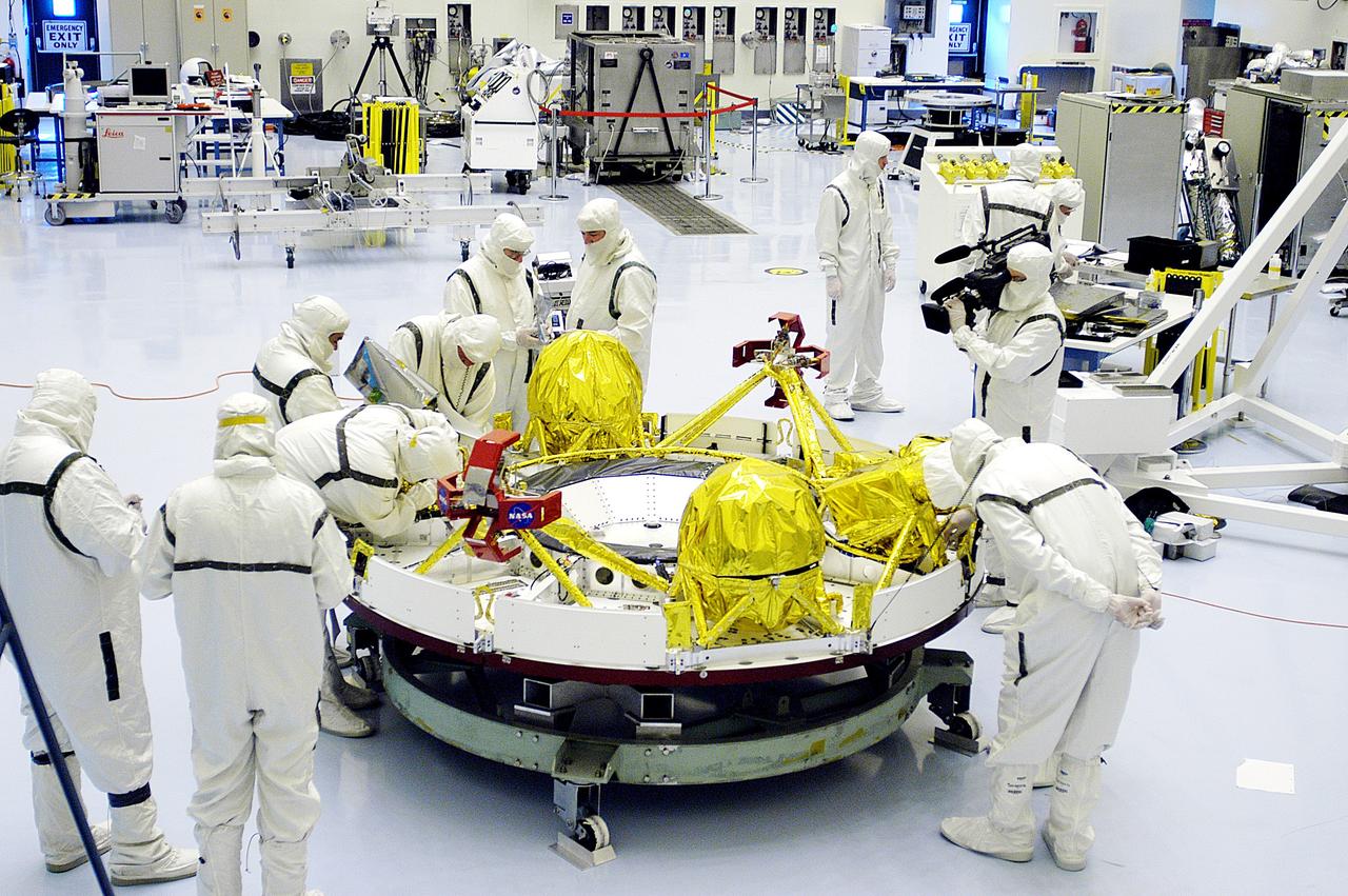 KENNEDY SPACE CENTER, FLA. - Technicians in the Payload Hazardous Servicing Facility prepare the cruise stage for Mars Exploration Rover 1 (MER-1) for integration with the aeroshell, the entry vehicle.   NASA’s twin Mars Exploration Rovers are designed to study the history of water on Mars. These robotic geologists are equipped with a robotic arm, a drilling tool, three spectrometers, and four pairs of cameras that allow them to have a human-like, 3D view of the terrain. Each rover could travel as far as 100 meters in one day to act as Mars scientists' eyes and hands, exploring an environment where humans can’t yet go.  The MER-1 is scheduled to launch June 25 from Launch Pad 17-A, Cape Canaveral Air Force Station.