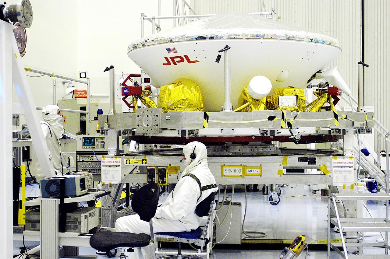 KENNEDY SPACE CENTER, FLA. - The aeroshell, the entry vehicle for Mars Exploration Rover 1 (MER-1), is ready for integration with its cruise stage, seen here below the backshell.  What appears to be the top half of the aeroshell is the heat shield.  NASA’s twin Mars Exploration Rovers are designed to study the history of water on Mars. These robotic geologists are equipped with a robotic arm, a drilling tool, three spectrometers, and four pairs of cameras that allow them to have a human-like, 3D view of the terrain. Each rover could travel as far as 100 meters in one day to act as Mars scientists' eyes and hands, exploring an environment where humans can’t yet go.  The MER-1 is scheduled to launch June 25 from Launch Pad 17-A, Cape Canaveral Air Force Station.