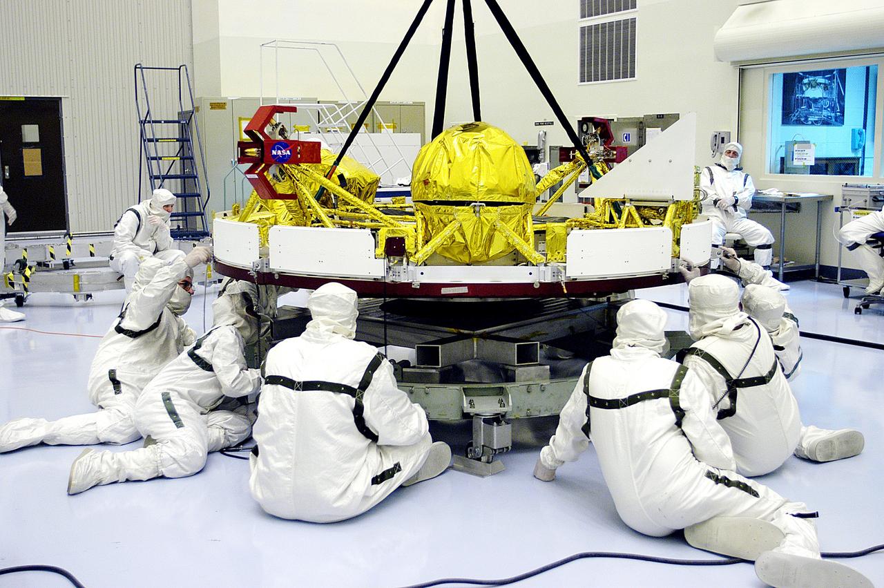 KENNEDY SPACE CENTER, FLA. - In the Payload Hazardous Servicing Facility, workers check the cruise stage of Mars Exploration Rover 1 (MER-1) being lifted off a stand.  The cruise stage will be integrated with the aeroshell, the entry vehicle.   NASA’s twin Mars Exploration Rovers are designed to study the history of water on Mars. These robotic geologists are equipped with a robotic arm, a drilling tool, three spectrometers, and four pairs of cameras that allow them to have a human-like, 3D view of the terrain. Each rover could travel as far as 100 meters in one day to act as Mars scientists' eyes and hands, exploring an environment where humans can’t yet go.  The MER-1 is scheduled to launch June 25 from Launch Pad 17-A, Cape Canaveral Air Force Station.