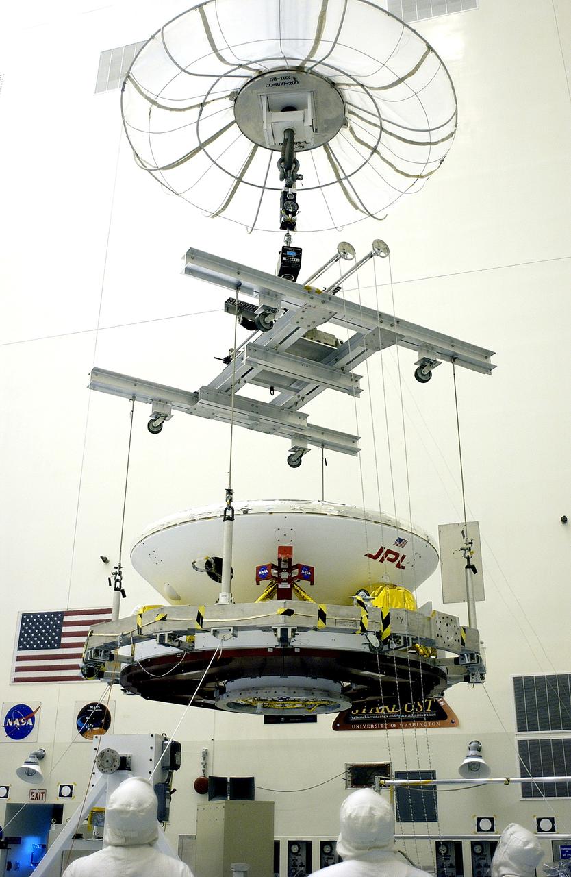KENNEDY SPACE CENTER, FLA. - In the Payload Hazardous Servicing Facility, an overhead crane lifts the Mars Exploration Rover 2 (MER-2) to move it to a spin table.  NASA’s twin Mars Exploration Rovers are designed to study the history of water on Mars. These robotic geologists are equipped with a robotic arm, a drilling tool, three spectrometers, and four pairs of cameras that allow them to have a human-like, 3D view of the terrain. Each rover could travel as far as 100 meters in one day to act as Mars scientists' eyes and hands, exploring an environment where humans can’t yet go.  The MER-2 is scheduled to launch June 5 from Launch Pad 17-A, Cape Canaveral Air Force Station.