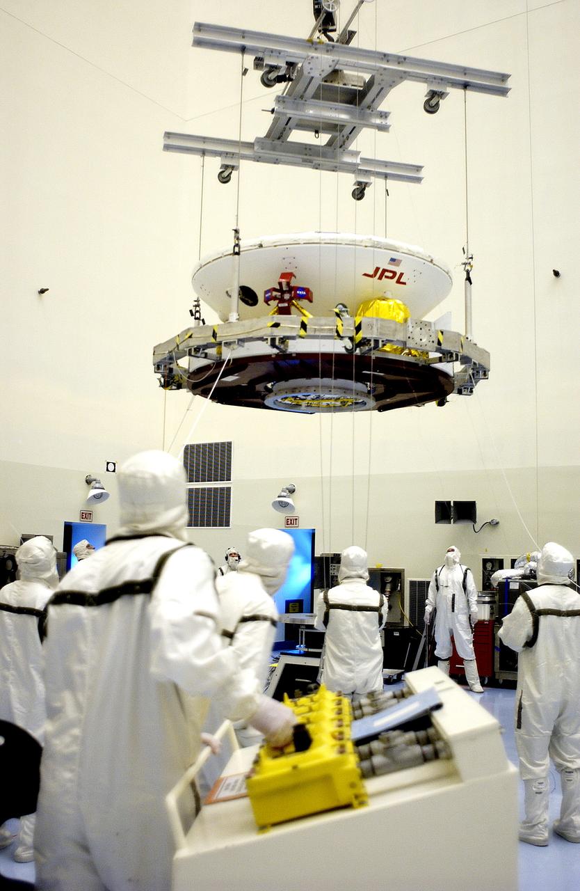 KENNEDY SPACE CENTER, FLA. - In the Payload Hazardous Servicing Facility, an overhead crane lifts the Mars Exploration Rover 2 (MER-2) to move it to a spin table.  NASA’s twin Mars Exploration Rovers are designed to study the history of water on Mars. These robotic geologists are equipped with a robotic arm, a drilling tool, three spectrometers, and four pairs of cameras that allow them to have a human-like, 3D view of the terrain. Each rover could travel as far as 100 meters in one day to act as Mars scientists' eyes and hands, exploring an environment where humans can’t yet go.  The MER-2 is scheduled to launch June 5 from Launch Pad 17-A, Cape Canaveral Air Force Station.