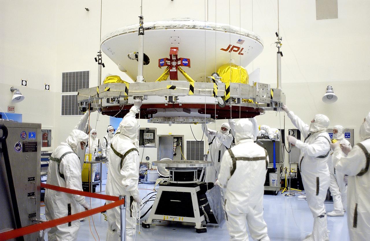 KENNEDY SPACE CENTER, FLA. - In the Payload Hazardous Servicing Facility, the Mars Exploration Rover 2 (MER-2) is lowered toward the spin table.  NASA’s twin Mars Exploration Rovers are designed to study the history of water on Mars. These robotic geologists are equipped with a robotic arm, a drilling tool, three spectrometers, and four pairs of cameras that allow them to have a human-like, 3D view of the terrain. Each rover could travel as far as 100 meters in one day to act as Mars scientists' eyes and hands, exploring an environment where humans can’t yet go.  The MER-2 is scheduled to launch June 5 from Launch Pad 17-A, Cape Canaveral Air Force Station.