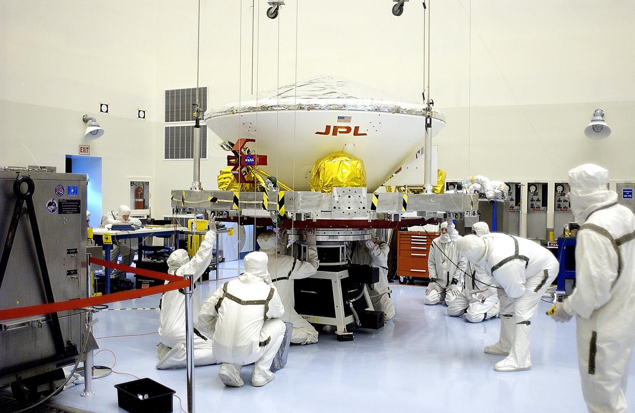 KENNEDY SPACE CENTER, FLA. - In the Payload Hazardous Servicing Facility, workers secure the Mars Exploration Rover 2 (MER-2) on the spin table.  NASA’s twin Mars Exploration Rovers are designed to study the history of water on Mars. These robotic geologists are equipped with a robotic arm, a drilling tool, three spectrometers, and four pairs of cameras that allow them to have a human-like, 3D view of the terrain. Each rover could travel as far as 100 meters in one day to act as Mars scientists' eyes and hands, exploring an environment where humans can’t yet go.  The MER-2 is scheduled to launch June 5 from Launch Pad 17-A, Cape Canaveral Air Force Station.