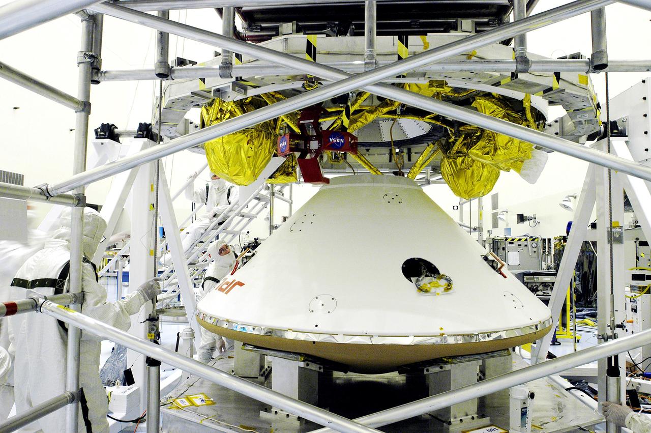 KENNEDY SPACE CENTER, FLA. - The Mars Exploration Rover 1 (MER-1) lander  (below) is mated to the cruise stage, seen above the lander.  NASA's twin Mars Exploration Rovers are designed to study the history of water on Mars. These robotic geologists are equipped with a robotic arm, a drilling tool, three spectrometers, and four pairs of cameras that allow them to have a human-like, 3D view of the terrain. Each rover could travel as far as 100 meters in one day to act as Mars scientists' eyes and hands, exploring an environment where humans can't yet go.  MER-1 is scheduled to launch June 25 as MER-B aboard a Delta II rocket from Cape Canaveral Air Force Station.