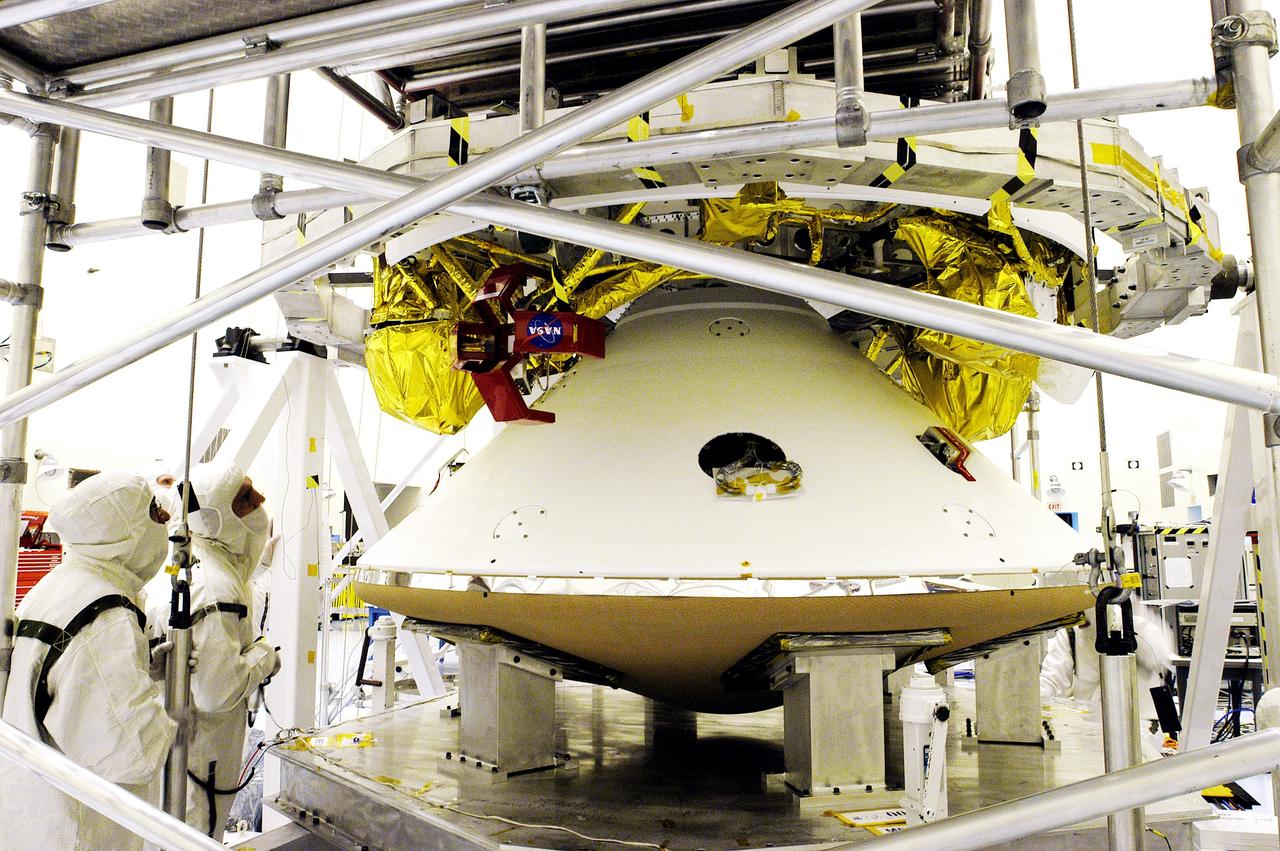 KENNEDY SPACE CENTER, FLA. - The Mars Exploration Rover 1 (MER-1) lander (below) is mated to the cruise stage, seen above the lander. NASA's twin Mars Exploration Rovers are designed to study the history of water on Mars. These robotic geologists are equipped with a robotic arm, a drilling tool, three spectrometers, and four pairs of cameras that allow them to have a human-like, 3D view of the terrain. Each rover could travel as far as 100 meters in one day to act as Mars scientists' eyes and hands, exploring an environment where humans can't yet go. MER-1 is scheduled to launch June 25 as MER-B aboard a Delta II rocket from Cape Canaveral Air Force Station.