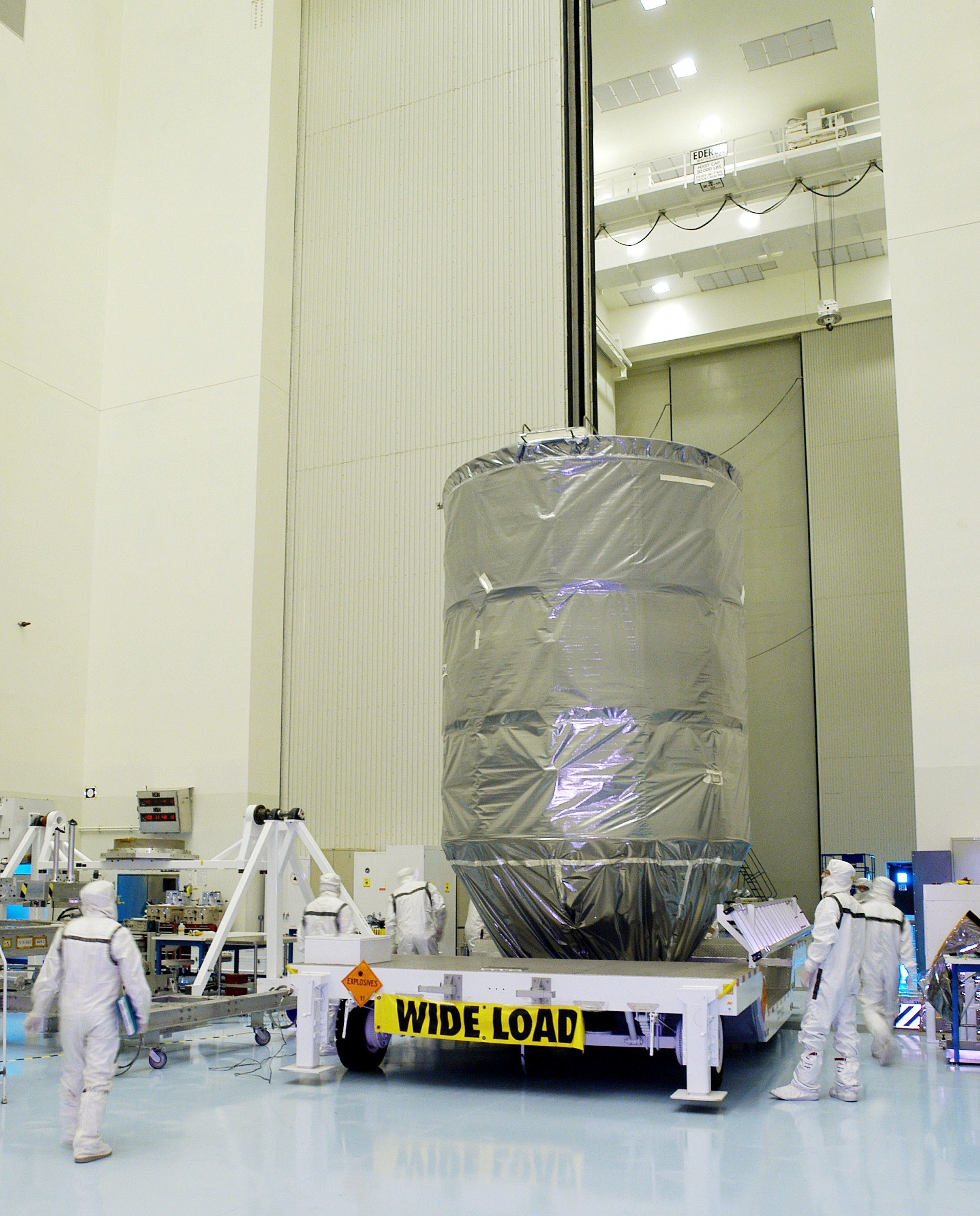 KENNEDY SPACE CENTER, FLA. - The Delta II rocket’s third stage rolls into the Payload Hazardous Servicing Facility.  It will be mated with the Mars Exploration Rover 2 (MER-2) and then installed into the transportation canister for transfer to the launch pad.  NASA's twin Mars Exploration Rovers are designed to study the history of water on Mars. These robotic geologists are equipped with a robotic arm, a drilling tool, three spectrometers, and four pairs of cameras that allow them to have a human-like, 3D view of the terrain. Each rover could travel as far as 100 meters in one day to act as Mars scientists' eyes and hands, exploring an environment where humans can't yet go.  MER-2 is scheduled to launch June 5 as MER-A aboard a Delta II rocket from Cape Canaveral Air Force Station.