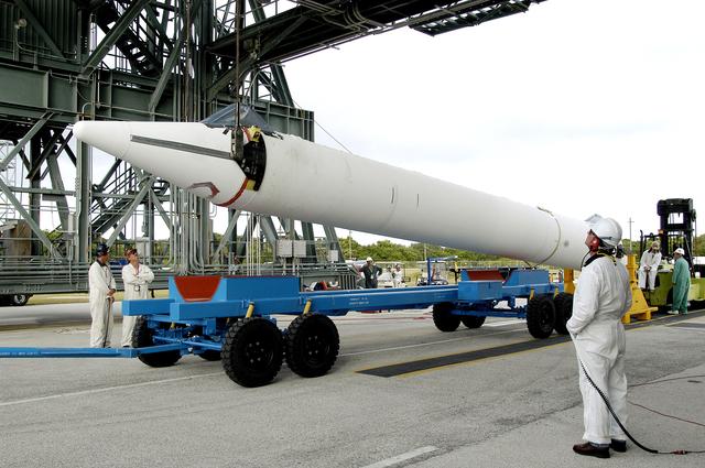 NASA image: KENNEDY SPACE CENTER, FLA. - On Launch Complex 17-B, Cape Canaveral Air Force Station, a solid rocket booster is raised off  its transporter to lift it to vertical.  It will be mated to the Delta II rocket for the Mars Exploration Rover 1 (MER-1) launch June 25.  NASA’s twin Mars Exploration Rovers are designed to study the history of water on Mars. These robotic geologists are equipped with a robotic arm, a drilling tool, three spectrometers, and four pairs of cameras that allow them to have a human-like, 3D view of the terrain. Each rover could travel as far as 100 meters in one day to act as Mars scientists' eyes and hands, exploring an environment where humans can’t yet go. MER-2 (MER-A) will launch June 5.