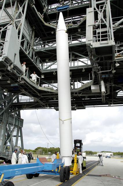 NASA image: KENNEDY SPACE CENTER, FLA. - On Launch Complex 17-B, Cape Canaveral Air Force Station, a solid rocket booster is lifted to vertical.  It will be mated to the Delta II rocket for the Mars Exploration Rover 1 (MER-1) launch June 25.  NASA’s twin Mars Exploration Rovers are designed to study the history of water on Mars. These robotic geologists are equipped with a robotic arm, a drilling tool, three spectrometers, and four pairs of cameras that allow them to have a human-like, 3D view of the terrain. Each rover could travel as far as 100 meters in one day to act as Mars scientists' eyes and hands, exploring an environment where humans can’t yet go.  MER-2 (MER-A) will launch June 5.