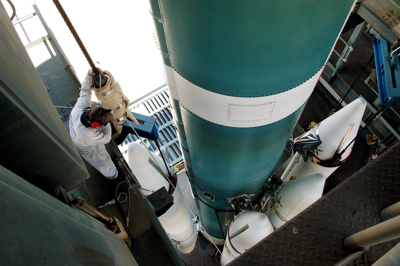 KENNEDY SPACE CENTER, FLA. - On the launch tower of Launch Complex 17-B, Cape Canaveral Air Force Station, solid rocket boosters are mated to the Delta II rocket for the Mars Exploration Rover 1 (MER-1) launch June 25.  NASA’s twin Mars Exploration Rovers are designed to study the history of water on Mars. These robotic geologists are equipped with a robotic arm, a drilling tool, three spectrometers, and four pairs of cameras that allow them to have a human-like, 3D view of the terrain. Each rover could travel as far as 100 meters in one day to act as Mars scientists' eyes and hands, exploring an environment where humans can’t yet go.  MER-2 (MER-A) will launch June 5.